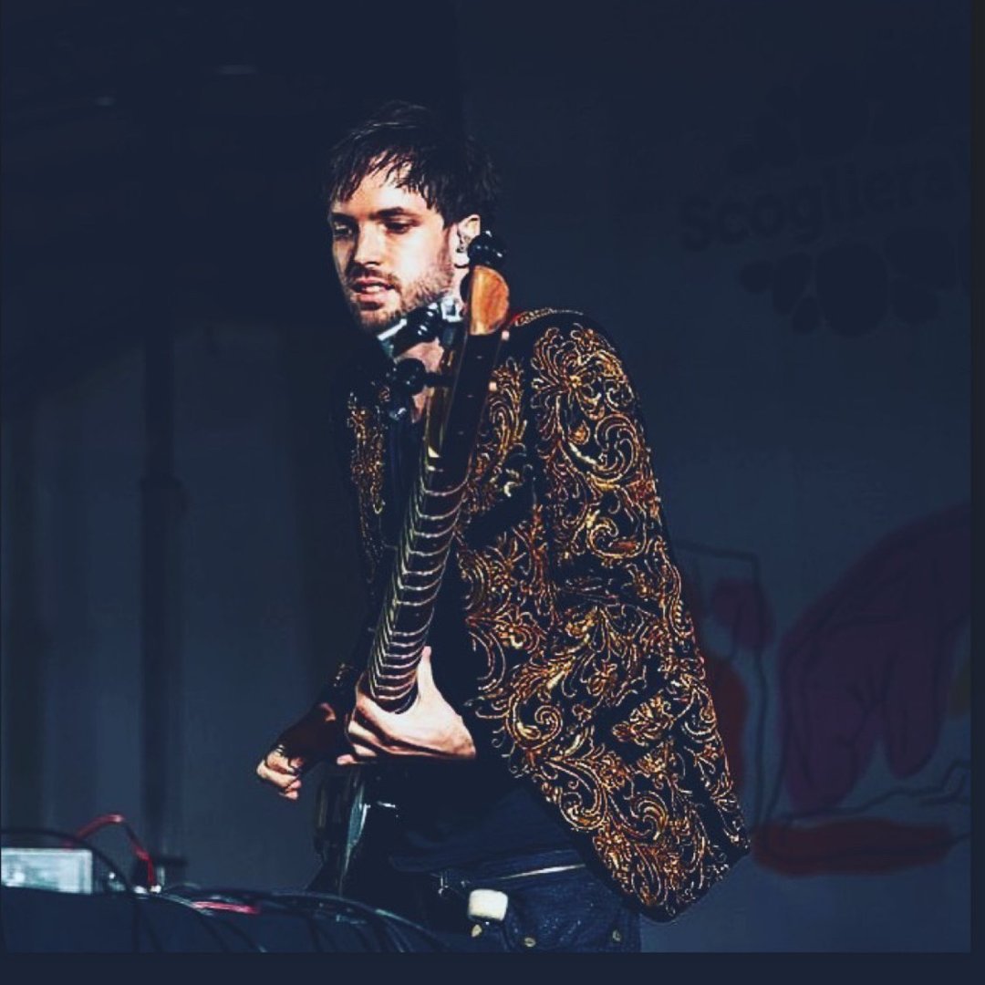 Tyler performing in gold jacket