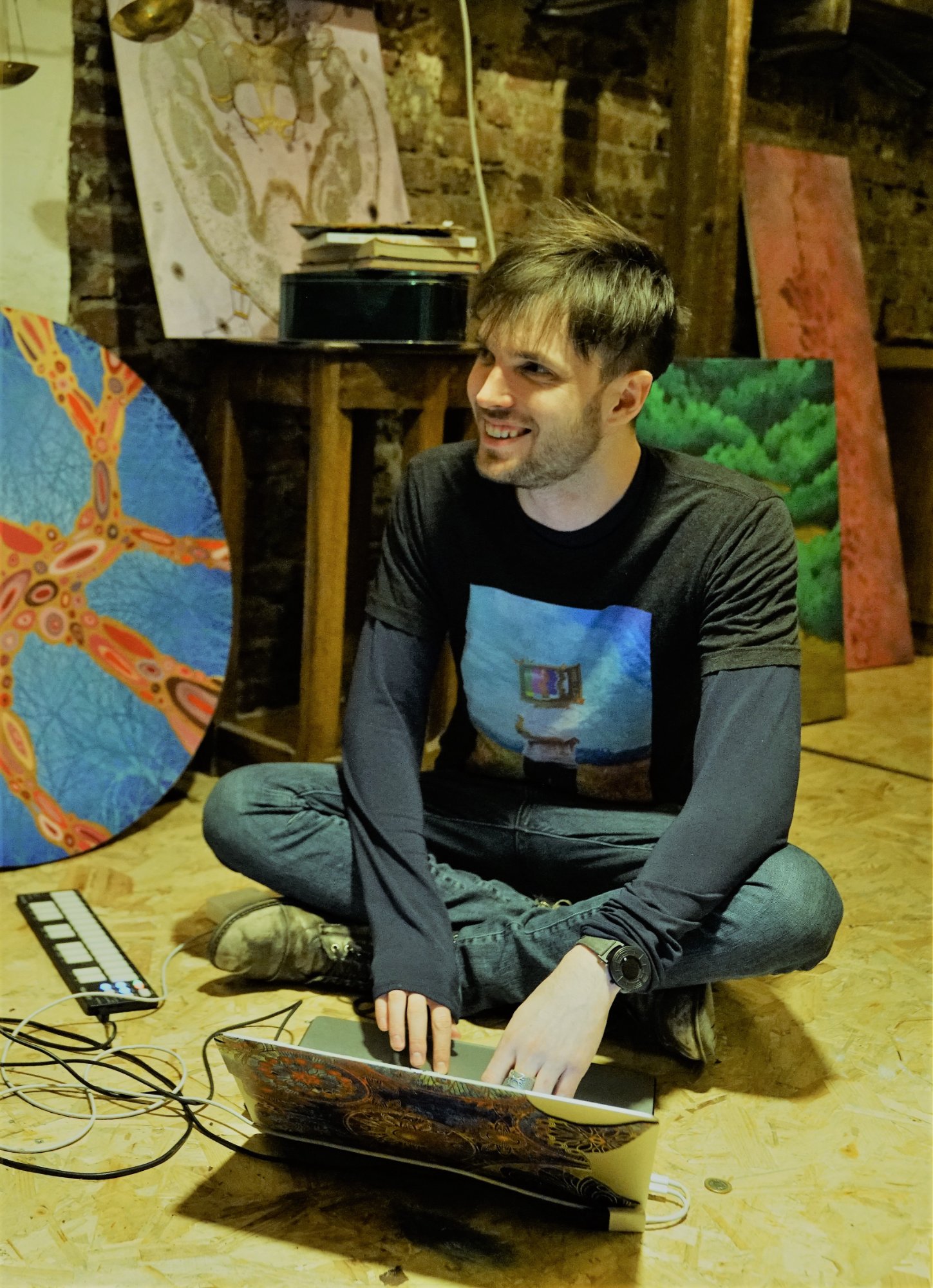 Tyler in studio with laptop